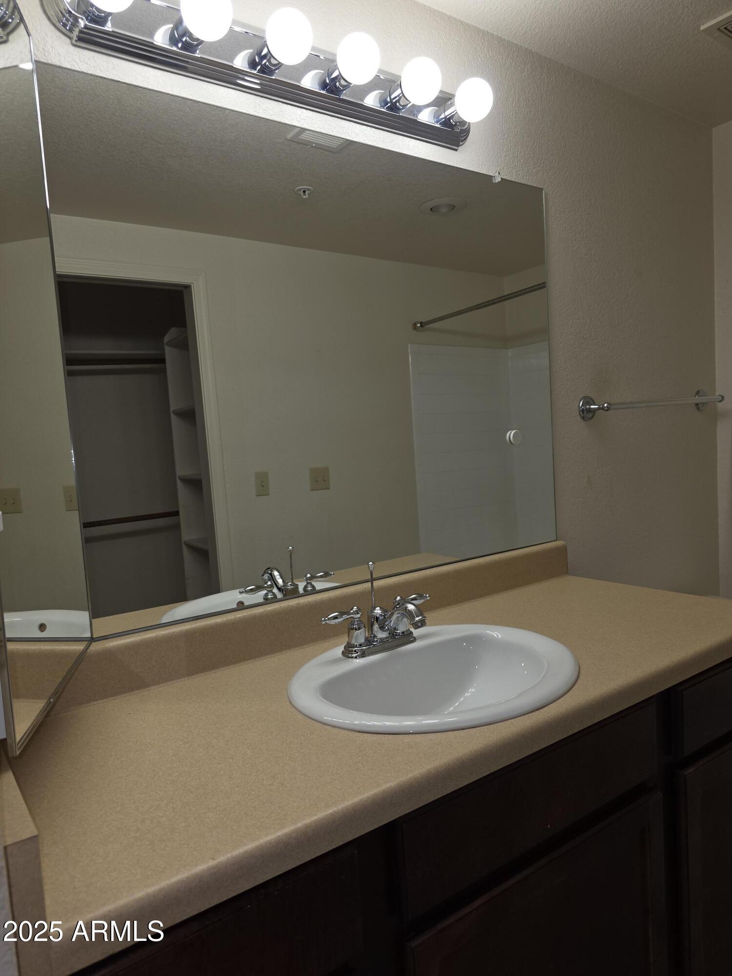750 East Northern Avenue, Unit 1052 Phoenix, AZ 85020 - Photo 12 of 15 a bathroom with a sink and a mirror