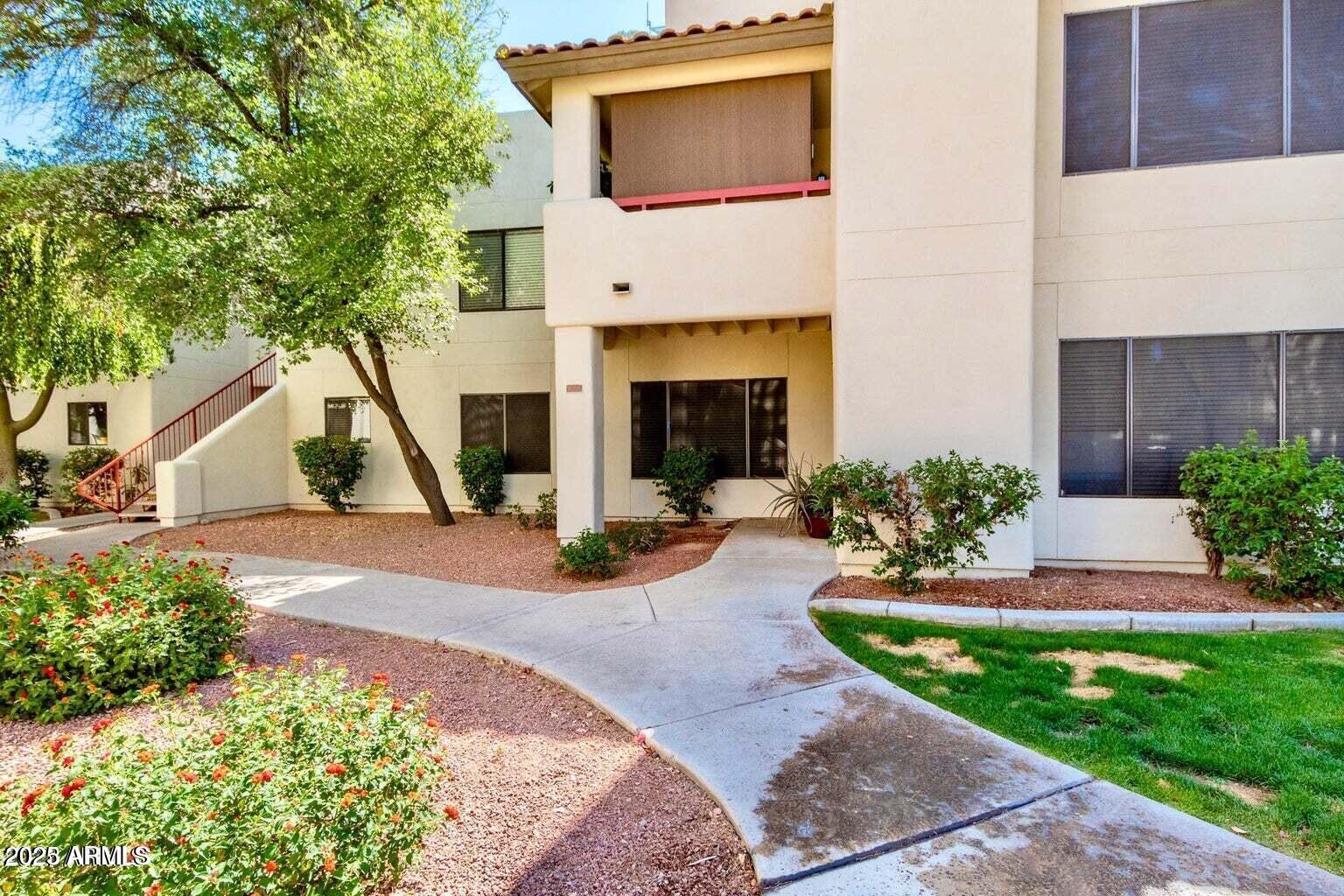 750 East Northern Avenue, Unit 1052 Phoenix, AZ 85020 - Photo 2 of 15 a front view of a house with a yard and potted plants