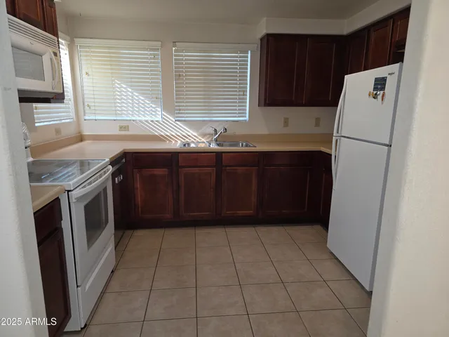 a kitchen with a refrigerator and a sink