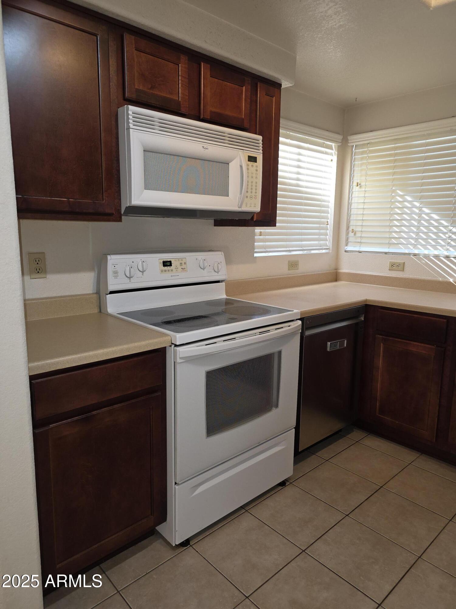 750 East Northern Avenue, Unit 1052 Phoenix, AZ 85020 - Photo 6 of 15 a kitchen with a cabinets and a stove top oven