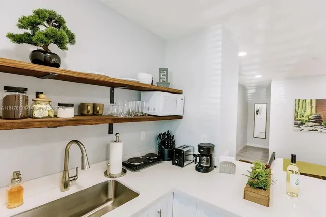 a kitchen with a sink a counter and cabinets