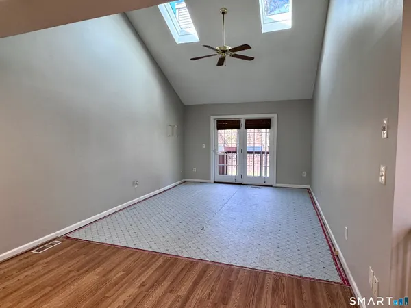 a view of an empty room and a window