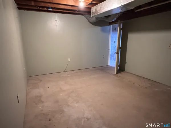 a view of empty room with wooden walls