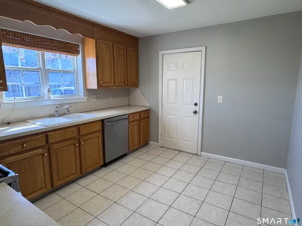 a kitchen with a sink window and cabinets