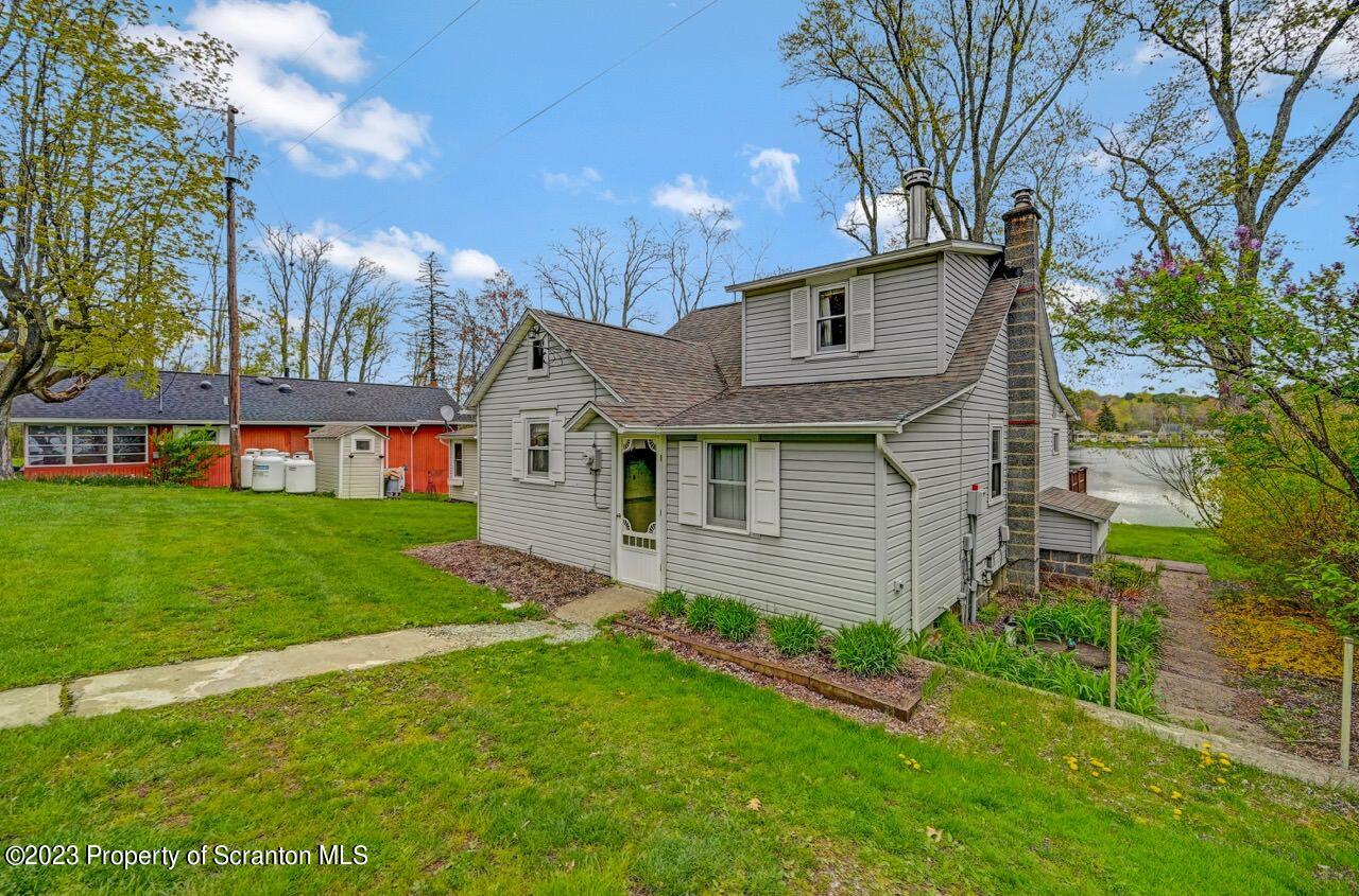 252 Baylor Road Fleetville, PA 18420 - Photo 1 of 50 a front view of a house with a garden