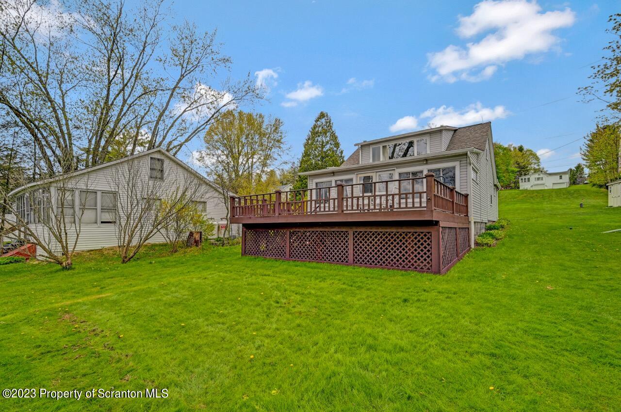 252 Baylor Road Fleetville, PA 18420 - Photo 17 of 50 a view of a house with a yard and a bench