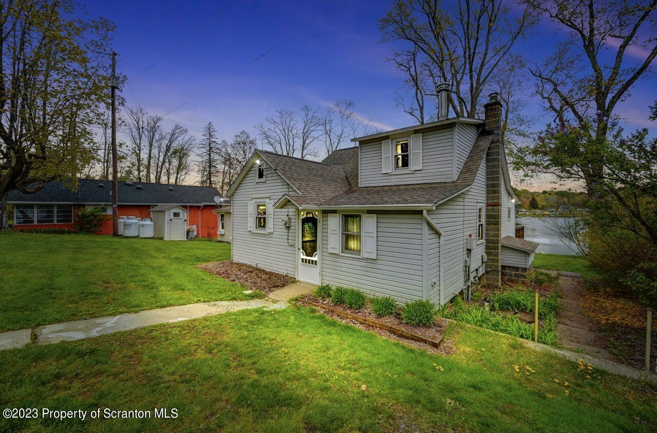 252 Baylor Road Fleetville, PA 18420 - Photo 3 of 50 a front view of a house with garden