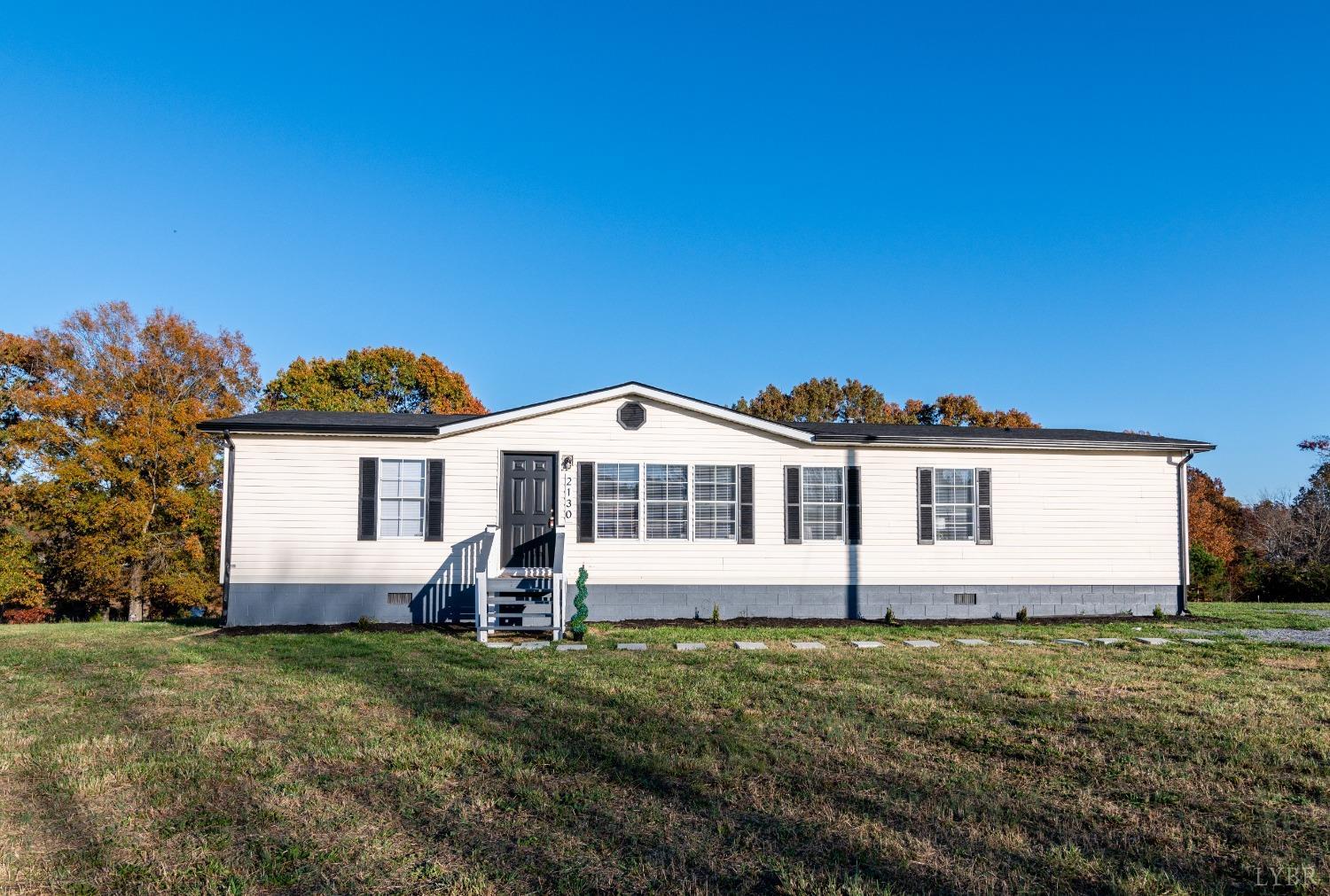 2130 Sandy Ridge Road Nathalie, VA 24577 - Photo 1 of 49 a front view of a house with a yard