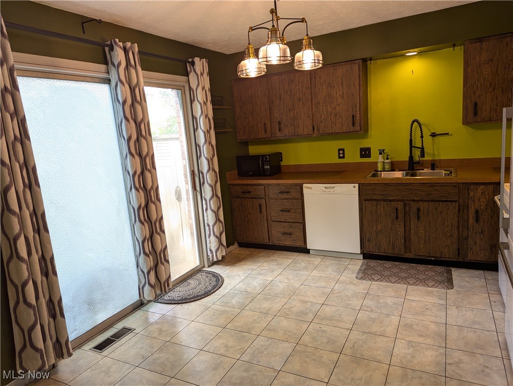 2500 Cleveland Road, Unit 202 Wooster, OH 44691 - Photo 5 of 22 Kitchen featuring sink, hanging light fixtures, light tile patterned floors, a chandelier, and dishwasher