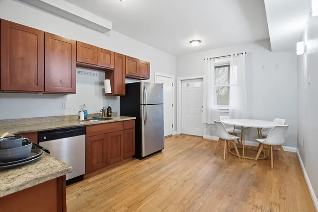 a kitchen with granite countertop a sink appliances and cabinets
