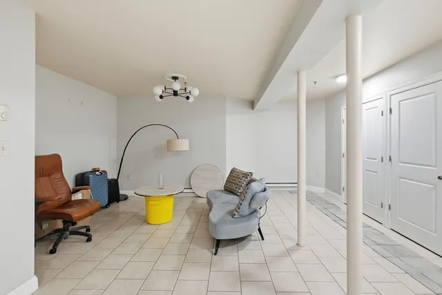 a living room with furniture and a mirror