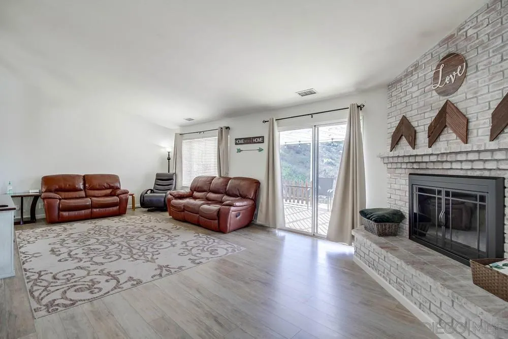 861 Peutz Valley Road Alpine, CA 91901 - Photo 13 of 42 a living room with furniture window and a fireplace