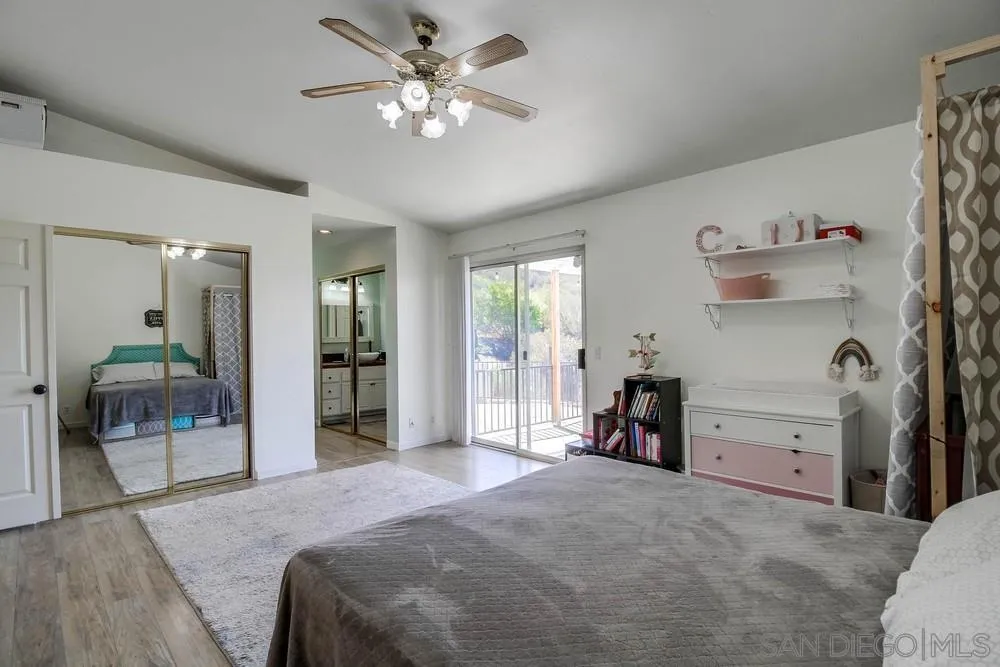 861 Peutz Valley Road Alpine, CA 91901 - Photo 15 of 42 a bedroom with a bed and a large mirror