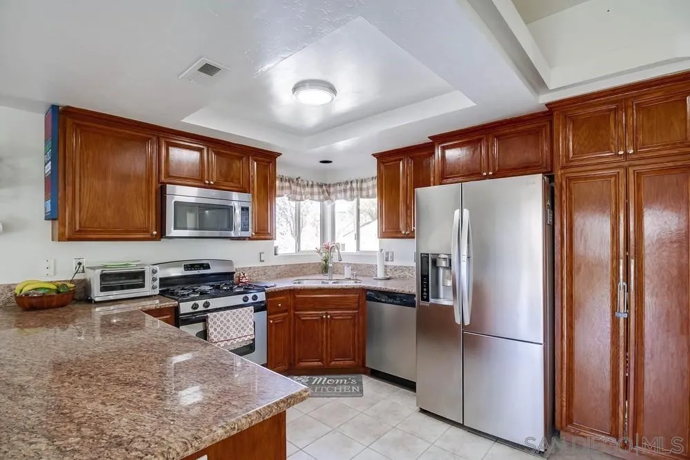 861 Peutz Valley Road Alpine, CA 91901 - Photo 4 of 42 a kitchen with stainless steel appliances granite countertop a refrigerator a sink dishwasher a stove and a refrigerator