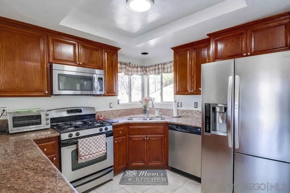 861 Peutz Valley Road Alpine, CA 91901 - Photo 5 of 42 a kitchen with stainless steel appliances granite countertop a refrigerator stove and sink