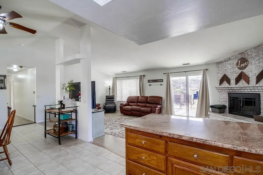 861 Peutz Valley Road Alpine, CA 91901 - Photo 6 of 42 a kitchen with sink cabinets and dining table view
