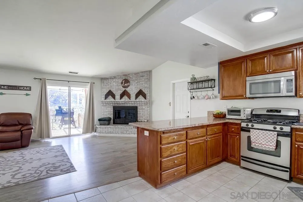 861 Peutz Valley Road Alpine, CA 91901 - Photo 7 of 42 a kitchen with stainless steel appliances granite countertop a stove and a sink