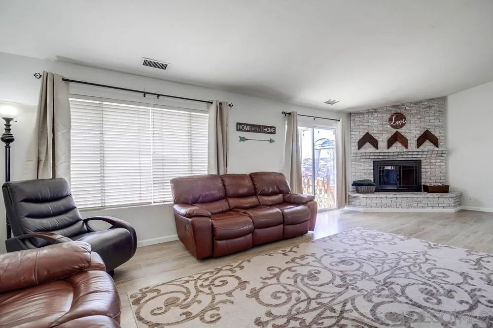 861 Peutz Valley Road Alpine, CA 91901 - Photo 10 of 42 a living room with furniture a window and a fireplace