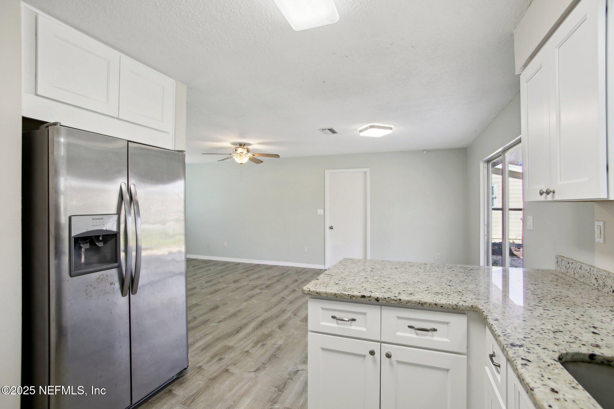 230 Lily Road St. Augustine, FL 32086 - Photo 17 of 39 a kitchen with granite countertop a refrigerator sink and stove