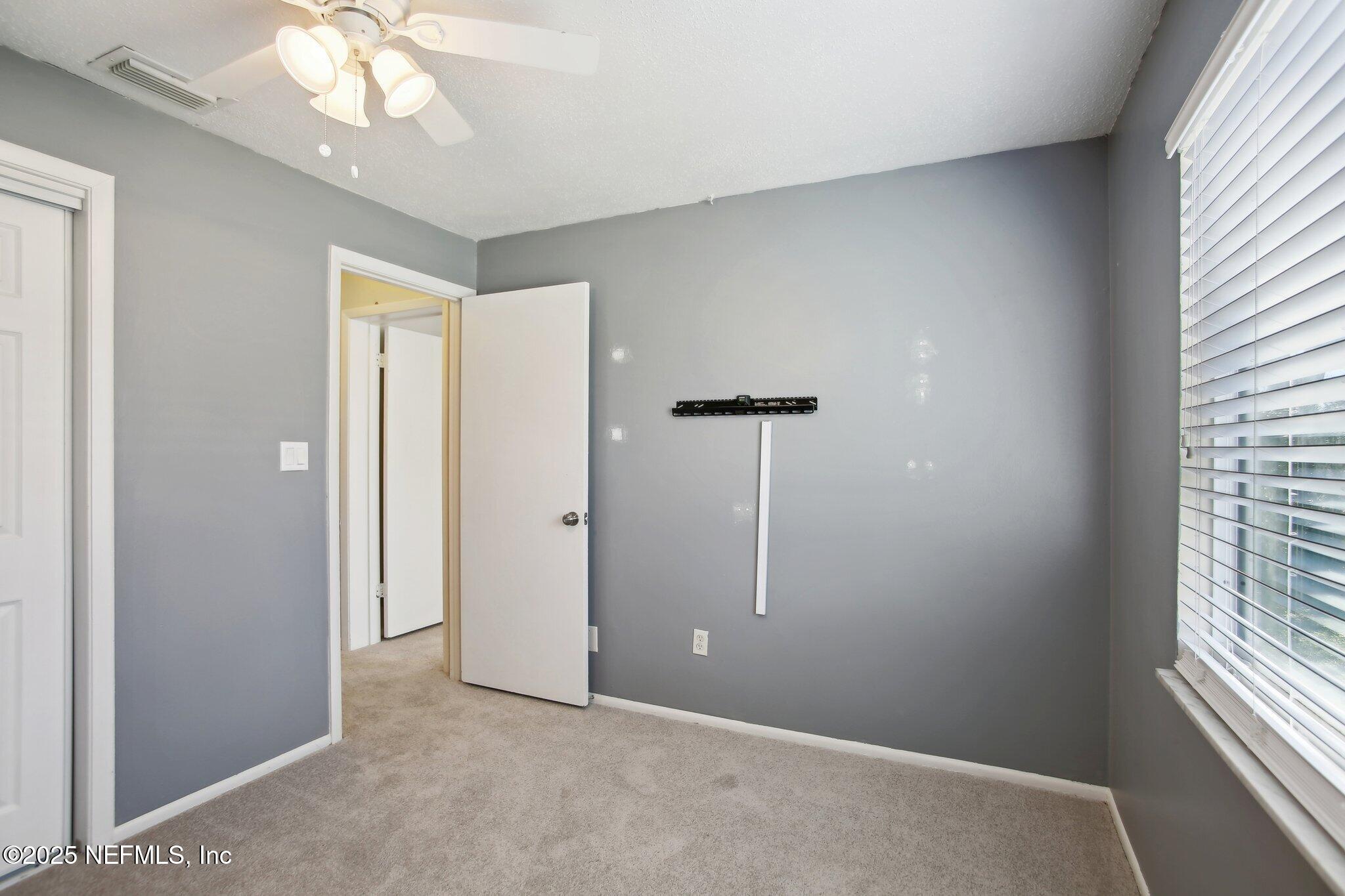 230 Lily Road St. Augustine, FL 32086 - Photo 19 of 39 an empty room with windows and entrance