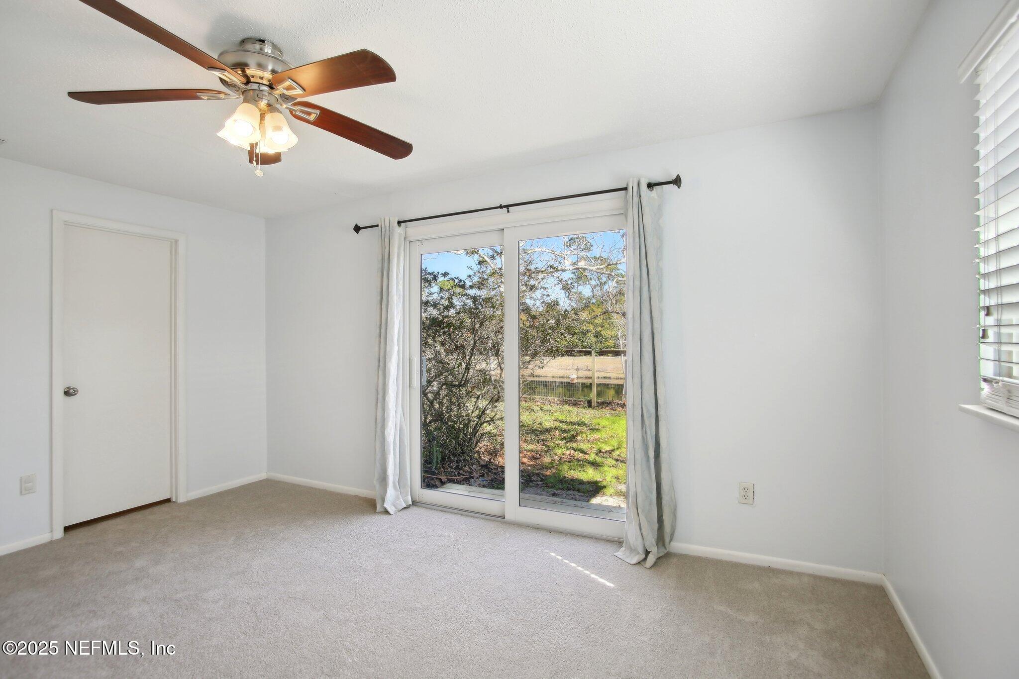 230 Lily Road St. Augustine, FL 32086 - Photo 30 of 39 a view of a livingroom with a ceiling fan and window