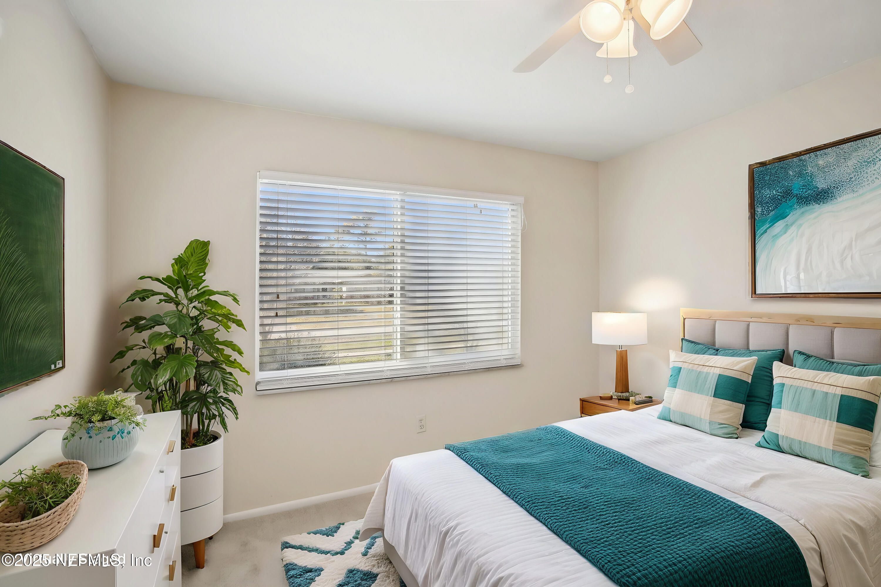 230 Lily Road St. Augustine, FL 32086 - Photo 8 of 39 a bedroom with a bed and a potted plant