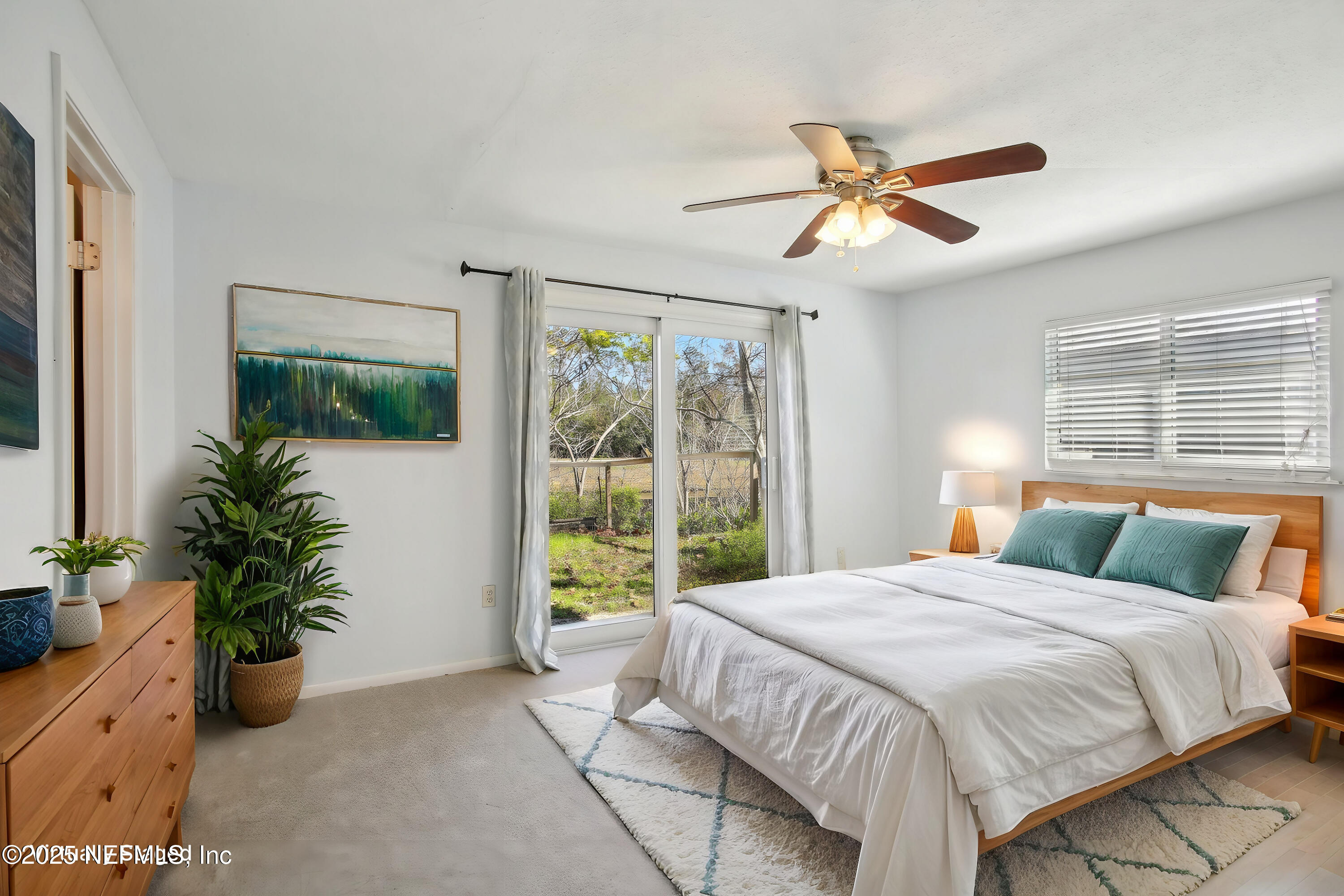 230 Lily Road St. Augustine, FL 32086 - Photo 10 of 39 a bedroom with a large bed and a potted plant