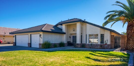 1221 Andrea Court Ridgecrest, CA 93555 - Photo 4 of 50 a front view of a house with a yard and potted plants