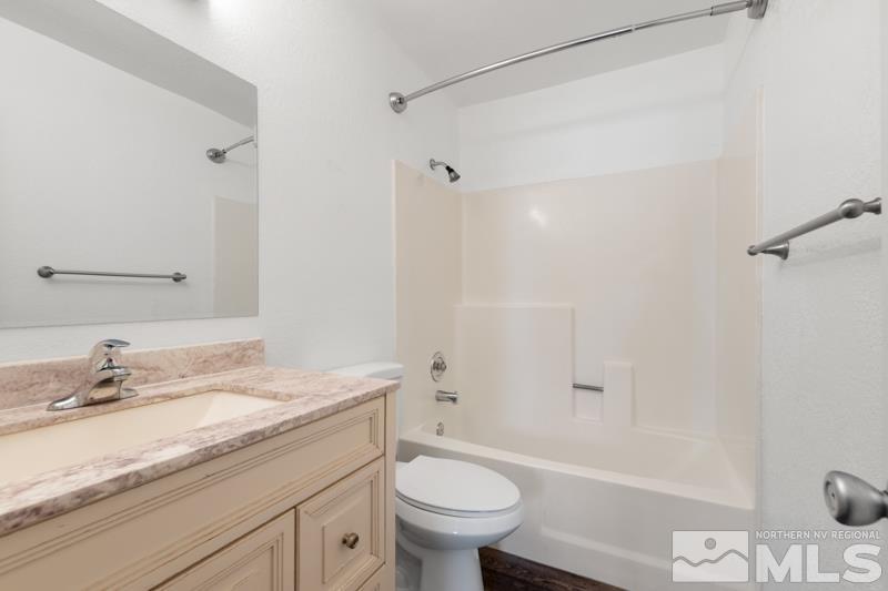 4701 Reggie Road Reno, NV 89502 - Photo 11 of 29 a bathroom with a granite countertop sink toilet and shower