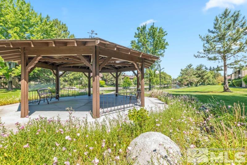 4701 Reggie Road Reno, NV 89502 - Photo 15 of 29 a backyard of a house with table and chairs under an umbrella