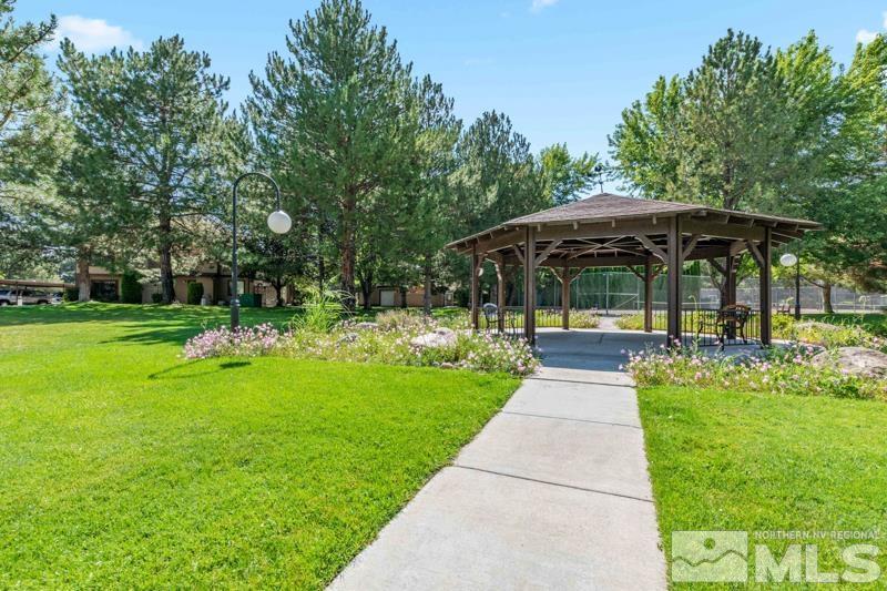 4701 Reggie Road Reno, NV 89502 - Photo 23 of 29 a view of a patio with a table and chairs under an umbrella