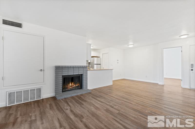 4701 Reggie Road Reno, NV 89502 - Photo 3 of 29 a view of empty room with wooden floor and fireplace
