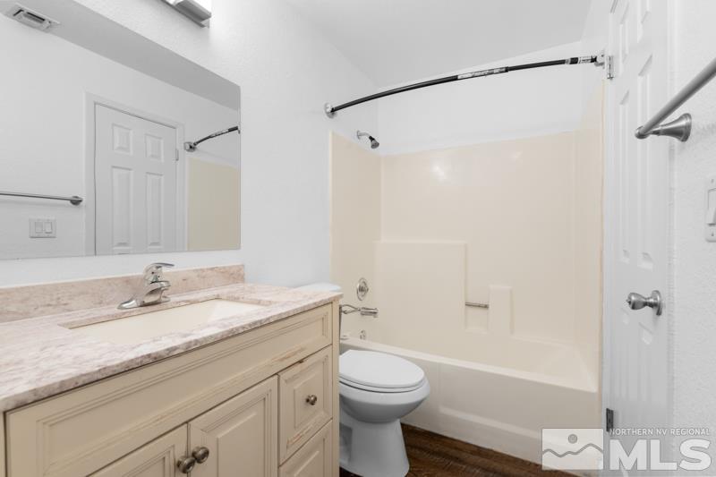 4701 Reggie Road Reno, NV 89502 - Photo 7 of 29 a bathroom with a granite countertop sink toilet and shower