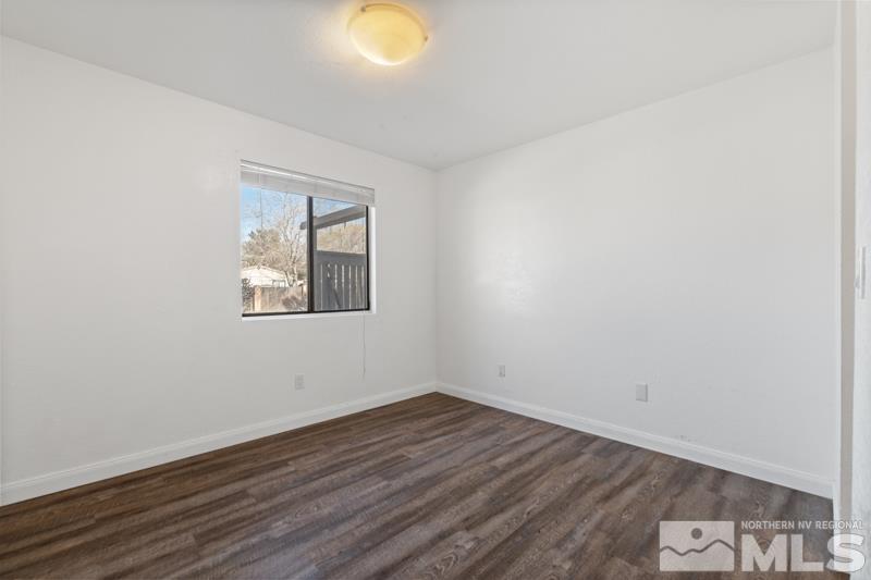 4701 Reggie Road Reno, NV 89502 - Photo 9 of 29 an empty room with wooden floor and window