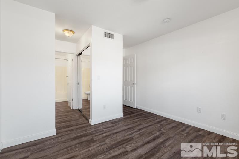 4701 Reggie Road Reno, NV 89502 - Photo 10 of 29 a view of an empty room with wooden floor
