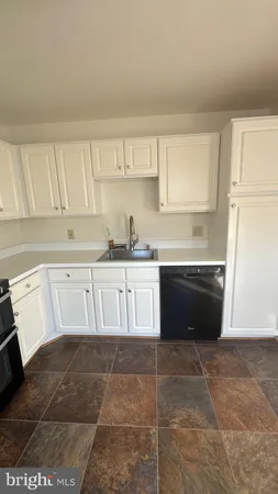 a kitchen with a cabinets and white stainless steel appliances