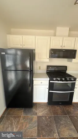 a kitchen with a stove and a refrigerator