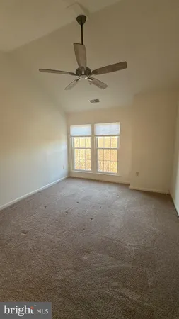 a view of room with a ceiling fan and window