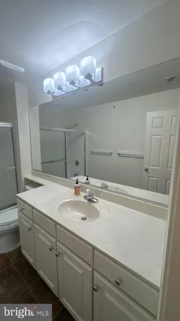 a bathroom with a sink a vanity and mirror