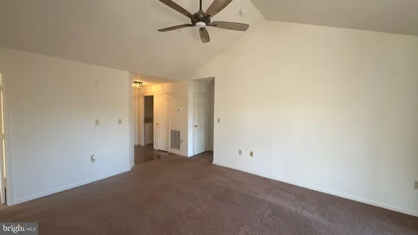 a view of a room with a ceiling fan