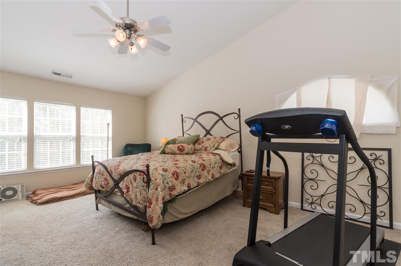8417 Whisper Ridge Place Raleigh, NC 27613 - Photo 11 of 24 a bed sitting in a room next to a window