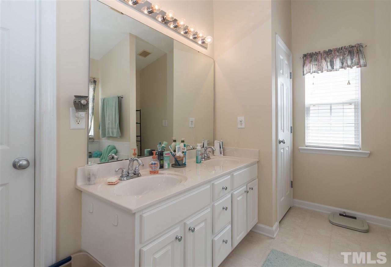 8417 Whisper Ridge Place Raleigh, NC 27613 - Photo 13 of 24 a bathroom with 2 sink and a mirror
