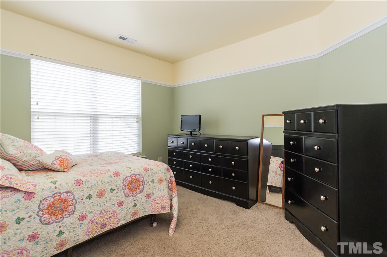 8417 Whisper Ridge Place Raleigh, NC 27613 - Photo 14 of 24 a bedroom with a bed and a window