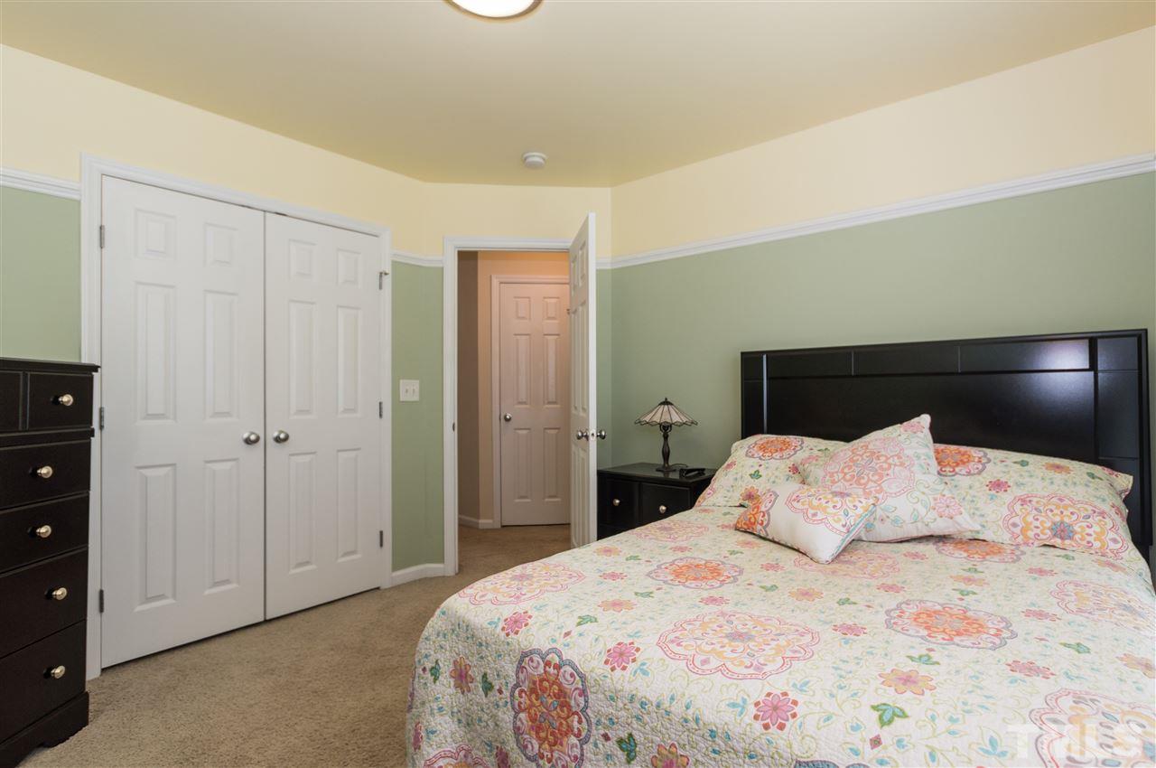 8417 Whisper Ridge Place Raleigh, NC 27613 - Photo 15 of 24 a bedroom with a bed and a closet