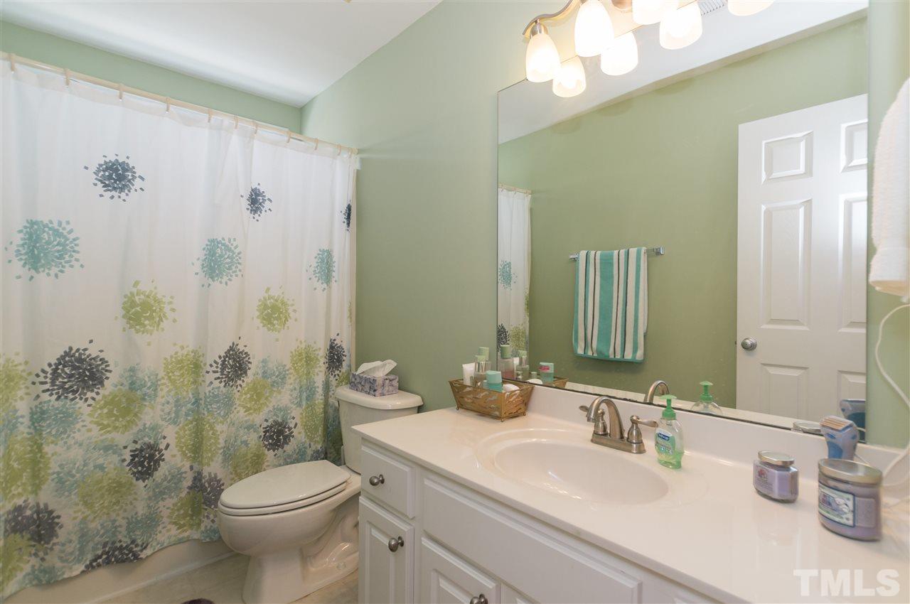 8417 Whisper Ridge Place Raleigh, NC 27613 - Photo 16 of 24 a bathroom with a sink a toilet and shower