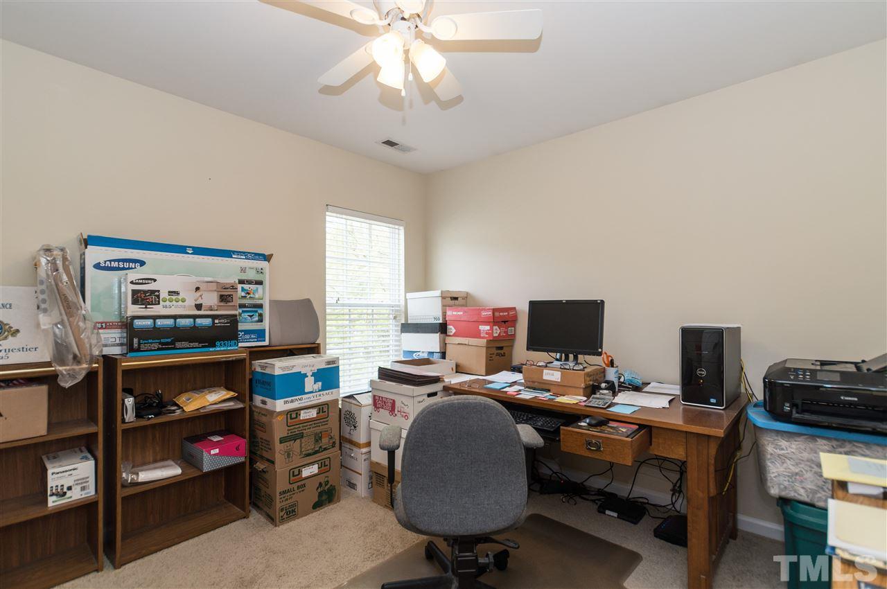 8417 Whisper Ridge Place Raleigh, NC 27613 - Photo 17 of 24 a view of a workspace with furniture and a window