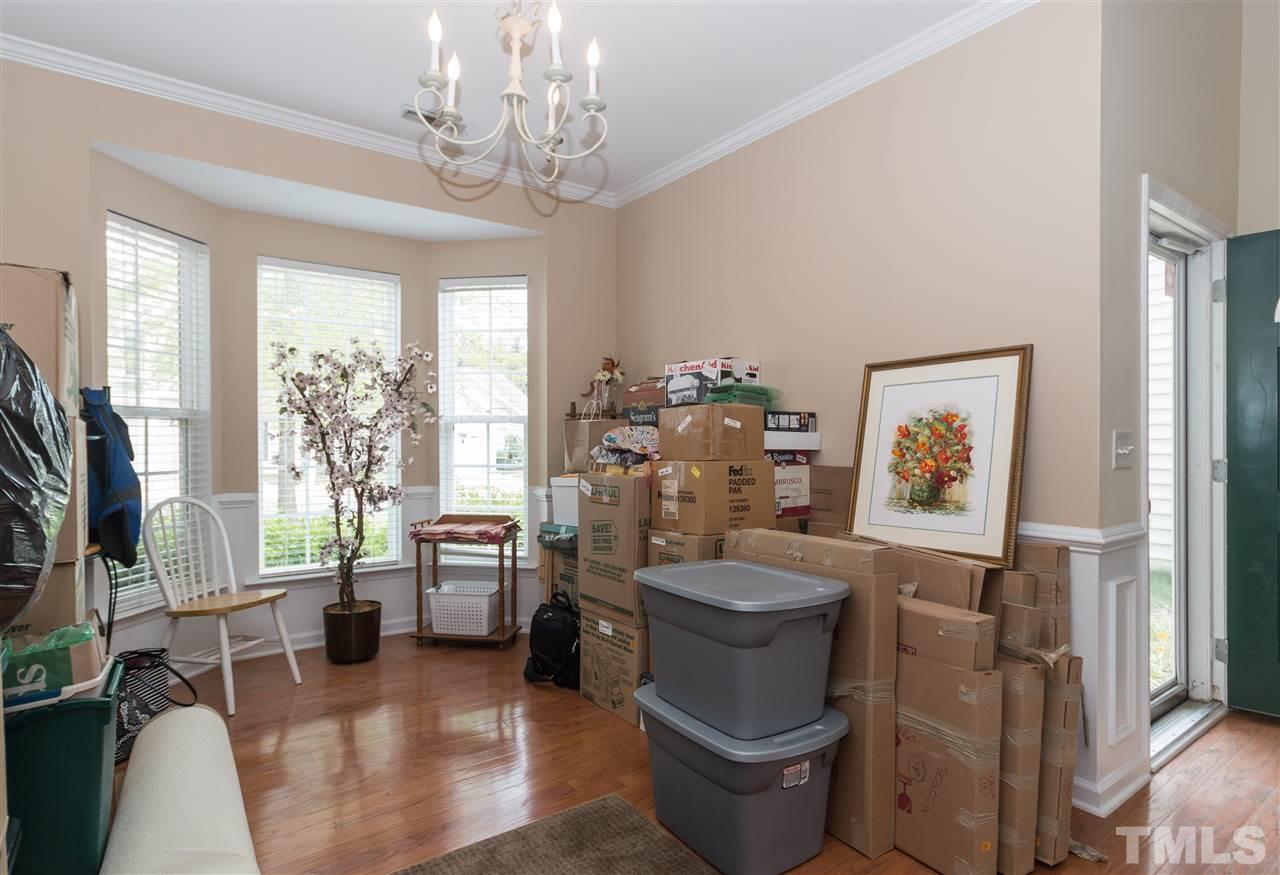 8417 Whisper Ridge Place Raleigh, NC 27613 - Photo 3 of 24 a living room with furniture a window and a flat screen tv