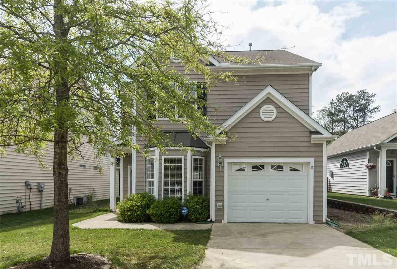 8417 Whisper Ridge Place Raleigh, NC 27613 - Photo 21 of 24 a front view of a house with a garden