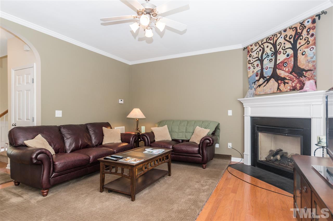 8417 Whisper Ridge Place Raleigh, NC 27613 - Photo 5 of 24 a living room with furniture and a fireplace