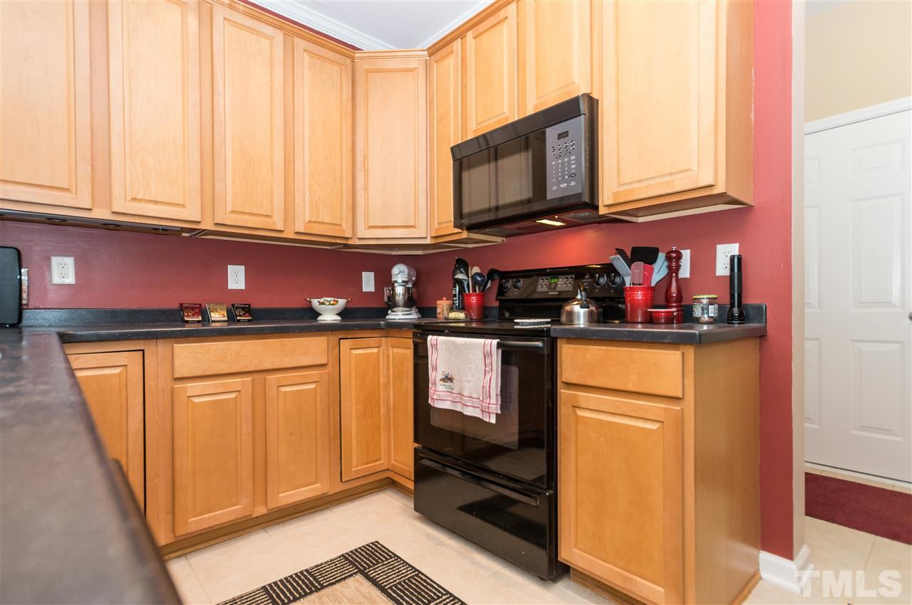 8417 Whisper Ridge Place Raleigh, NC 27613 - Photo 7 of 24 a kitchen with stainless steel appliances granite countertop a refrigerator and microwave
